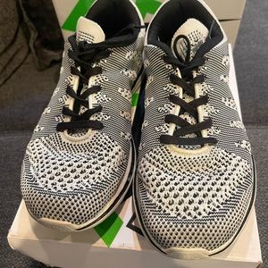 Black and white women’s APL sneakers